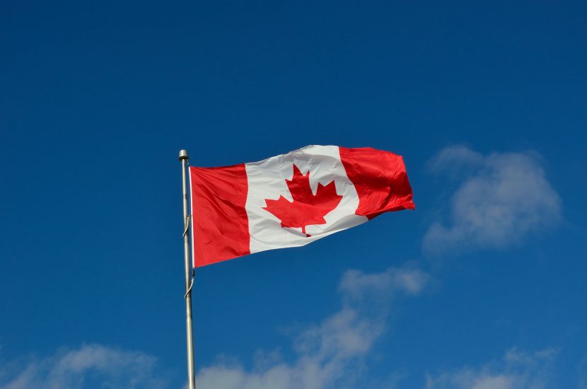 canadian flag canada wind blue sky
